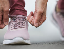 Hands tying an athletic shoe